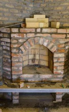 Building a fireplace in a house using old bricks. Beautiful bricklaying. Stock Photos