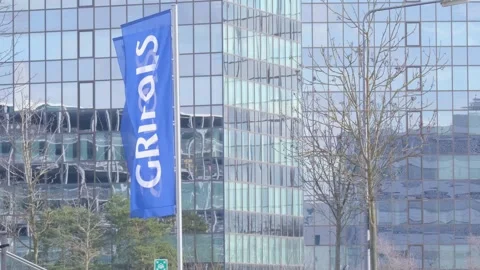 Building with flags GRIFOLS in blue, global healthcare company develops pla.. Video stock 265915402