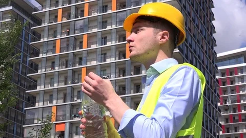 Building flat apartment developer drinking thirsty water from bottle engineer 4K Stock Footage 76045276