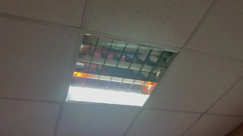 In the building, a fluorescent lamp flashes in the dark Stock Footage 251999336