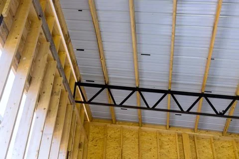Building frame composition ith timber joists roofing panels in construction site Stock Photos