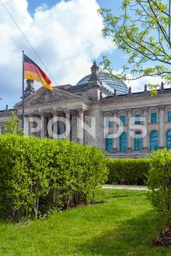 The building of the German Parliament the Reichstag and the national flag in Stock Photos
