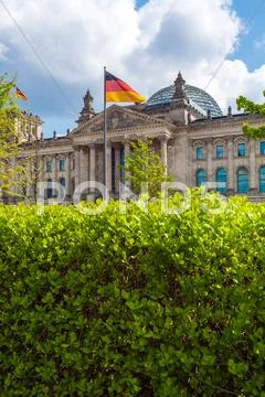The building of the German Parliament the Reichstag and the national flag in Stock Photos