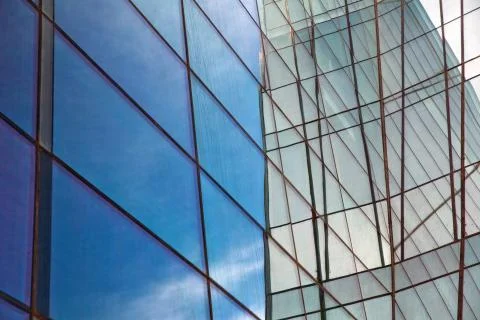 Building glass . Clouds Reflected in Windows of Modern Office Building. Stock Photos