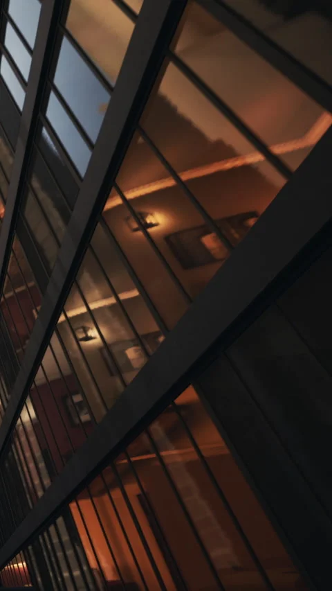 Building with glass windows showing reflections in evening light Stock Footage 339097888
