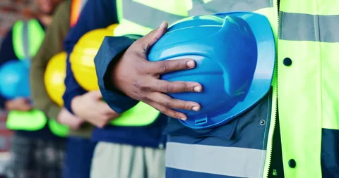 Building, hands and helmet with construction worker group on worksite for Video stock 336794476