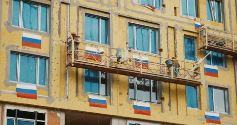 Building of a house in Russia, workers work at construction outdoors. Stock Footage 130660917