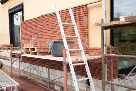 Building a house supporting structure for laying bricks around a wooden base Fotos Stock