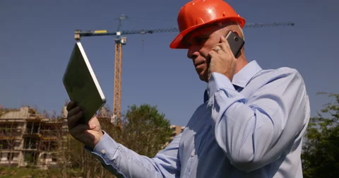 Building Industry Site Manager Cell Talk Team Worker Verify Tablet Project Plans Stock Footage 61450705