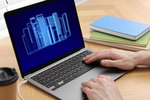 Building information modeling. Man working at laptop indoors, closeup. Digi.. Fotos de archivo