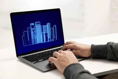 Building information modeling. Man working at laptop indoors, closeup. Digi.. Fotos de archivo