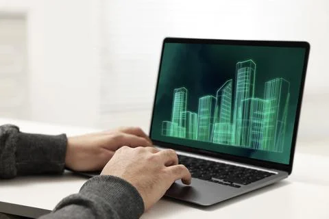 Building information modeling. Man working at laptop indoors, closeup. Digi.. Fotos de archivo