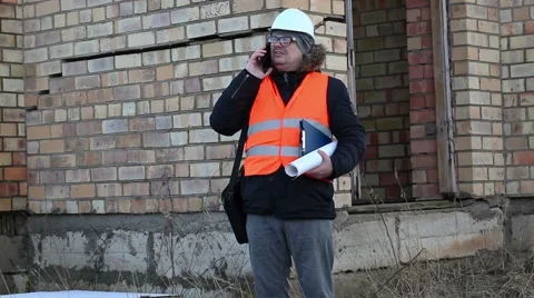 Building inspector with documents checking the building Stock Footage 60750762