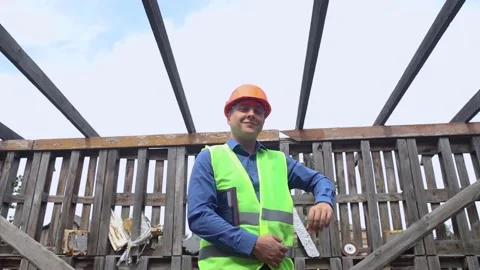 Building inspector. Man in a hard hat and a yellow reflective vest examines dama Stock Footage 205552276