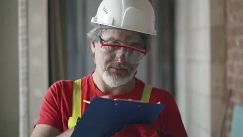 Building inspector in safety gear checking construction site Stock Footage 133637944