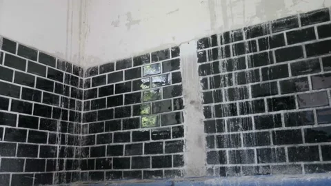 Building interior with old tiles, plaster falling off from the wall Stock Footage 100447199