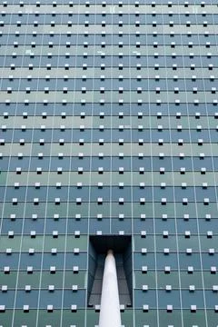 A building with a large window and a white pole sticking out of it Foto stock