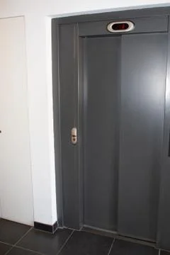 Building lift Elevator Doors Closed grey in white wall Fotos de archivo