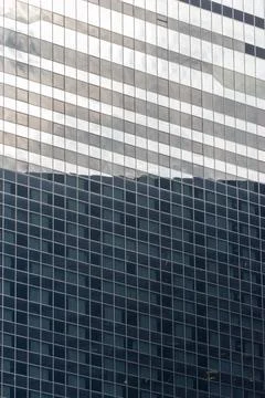 A building with a lot of windows and a reflection of the sky Foto stock