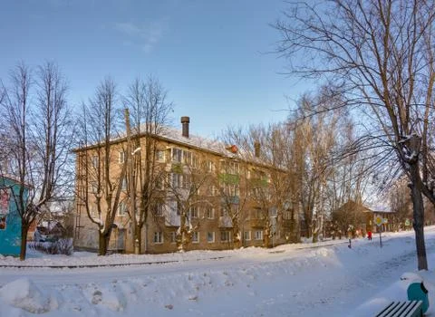 The building is made of silicate brick on a snowy street in a provincial village Stock Photos