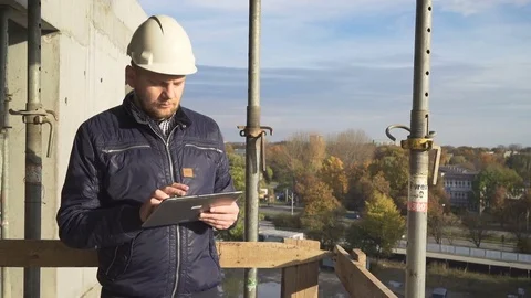Building manager browsing tablet, smiling to camera. Slider shot. 库存影片 72361280