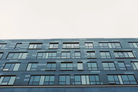 Building with many windows seen from below on a cloudy day in an urban settin Foto stock