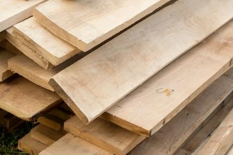Building material a stack of old beige boards stacked for building a house Stock Photos