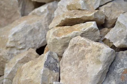 Building material stone. The light stone is straightened in a pile. Stock Photos