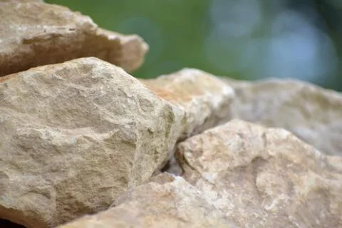 Building material stone. The light stone is straightened in a pile. Stock Photos