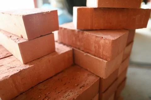 Building materials are on floor, stack red bricks Foto stock
