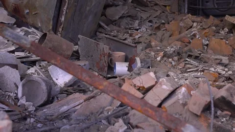 Building materials like bricks and pipes are scattered on the ground Stock Footage 264323213