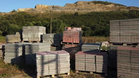 Building materials in packages, pallets stored in field at construction site. Stock Footage 136690201