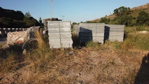 Building materials in packages, pallets stored in field at construction site. Stock Footage 136690214