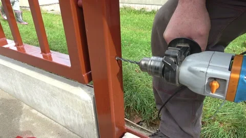 Building a metal fence with a drill and screw. Stock Footage 141035053