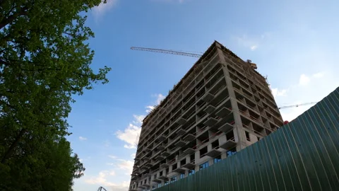Building of new multistorey residential complex in city for young families Stock Footage 243709046