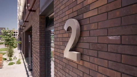 Building number two sign mounted on brick residential facade Vidéo 342610617
