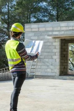 Building occupation, reading a plan on a construction site Stock Photos