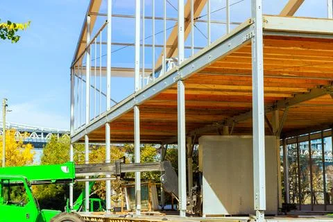 Building office is framed by metal structures of steel beams while a Photos