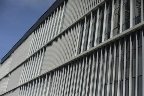 Building is outside. Windows in building. Vertical lines in architecture. Stock Photos