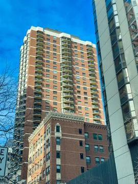 Building overview showing a tall brick structure beside a modern glass buil.. Stock Photos