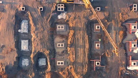 Building plot with poured concrete piling foundations and many concrete parts Stock Footage 167926320