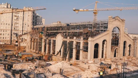 Building in the Process of Construction. Labor working in big construction site Stock Footage 108555372