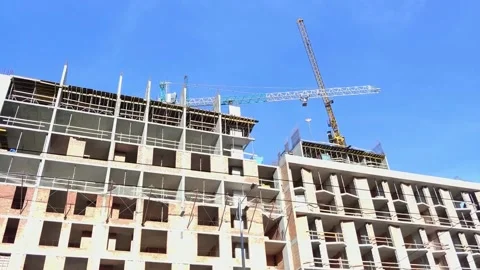 Building in progress at construction site with two tall cranes Stockbeeldmateriaal 135580731