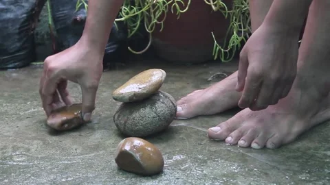 Building a pyramid of stone Stock Footage 139356629