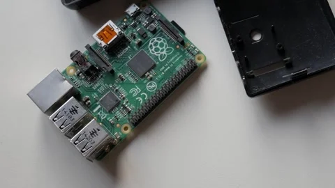 Building a Raspberry Pi project on a tech workbench featuring detailed circuit Stock Footage 312203986
