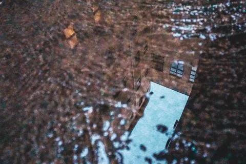 Building reflected in puddle Stock Photos
