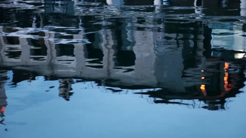 The building is reflected on the surface ripples of water in the summer evening  Stock Footage 147629582