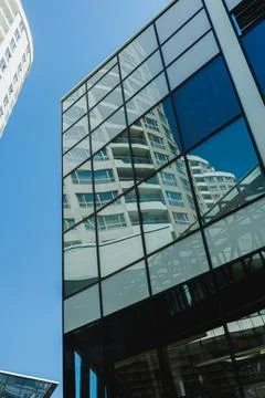 Building reflection in modern architecture with clear blue sky during daytime Fotos Stock