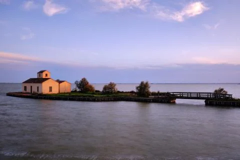 Building reflection in silk effect water in Comacchio, Delta del Po' Stock Photos