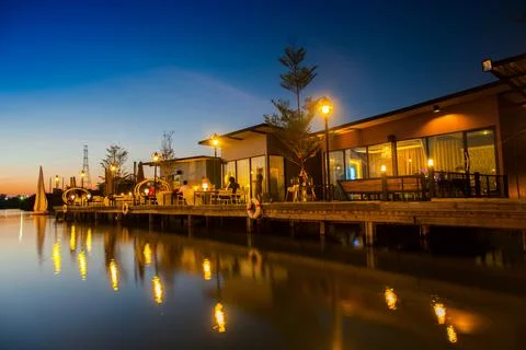 Building reflection on water at sunset time Stock Photos